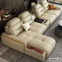 a living room with a large sectional couch and coffee table in the center, along with two end tables on either side