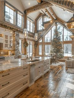 a large kitchen with wooden floors and lots of windows on the side of the wall