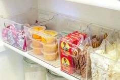 an organized refrigerator with food and snacks in plastic containers