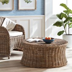 a wicker coffee table with a bowl of fruit on it in a living room