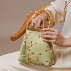 Description Inspired by the serene beauty of pear blossoms, our silk floral bag embodies the purity and tranquility found in nature's simplest yet most exquisite moments. Just as the pear trees blossom with a gentle, clear radiance, our design captures this essence with its clean and elegant lines. The bag’s pristine white hue mirrors the pure and unadorned charm of pear blossoms, offering a refreshing and refined aesthetic. Even amidst a flurry of activity, this design maintains a sense of calm Gold Bags For Spring Gift, Elegant Rectangular Spring Evening Bag, Elegant Rectangular Evening Bag For Spring, Elegant Shoulder Bag For Spring Gift, Handheld Shoulder Bag For Spring Formal Events, Luxury Green Bag For Spring, Spring Formal Pouch Shoulder Bag, Elegant Spring Rectangular Bags, Formal Spring Pouch Shoulder Bag