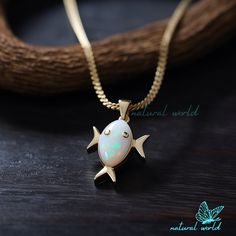 14k Gold Plated Gemstone Fish Pendant, Cute Opal Fish Pendant, Carved Gemstone Fish Pendant, Handmade Fish Pendant, Designer Fish Pendant 🌺Item Details🌺 Item Name : Fish Pendant ( Only Pendant ) Metal : 925 Silver Size :  Stone : Ethiopian Opal                                         🌊 *About Us: Natural World Jewelry* 🐚 At Natural World Jewelry, we're passionate about bringing the serene beauty of the ocean to your everyday life. Our artisanal jewelry pieces are lovingly handcrafted using a diverse array of exquisite shells collected from the world's most breathtaking shorelines. 🐚 *Our Craftsmanship* Each piece of jewelry in our collection is a testament to the unique beauty found in nature. Our skilled artisans carefully select, shape, and polish each shell to create one-of-a-kind Lucky Fish, Fish Pendant, Gold Fish, Pendant Gold, Opal Pendants, Quartz Pendant, Ethiopian Opal, Natural World, Jewelry Earrings Studs