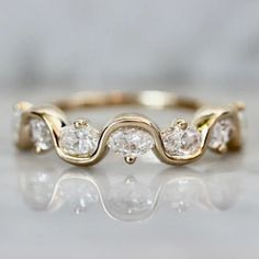 a gold ring with three diamonds on it