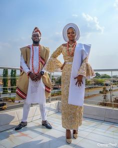 two people standing next to each other on a roof