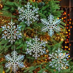 a christmas tree with snowflakes hanging from it