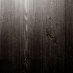 a black and white photo of wood planks with light coming from the top right corner