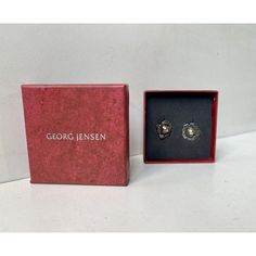 A set of 'Year' clip earrings by Georg Jensen. Based upon a design from circa 1900 these were relaunched in 2002. Floral design with silver-beads. Original box. Fully hallmarked. Measurements: 19x19x10 mm. Weight: approx 10 grams combined. This piece has an attribution mark,   I am sure that it is completely authentic and  take full responsibility for any authenticity   issues arising from misattribution Designer Silver Clip-on Earrings As Gift, Designer Silver Clip-on Earrings For Gift, Designer Sterling Silver Earrings As Gift, Designer Sterling Silver Earrings For Gifts, Designer Silver Earrings For Gift, Designer Silver Clip-on Earrings, Silver Clip-on Pearl Earrings As Gift, Silver Clip-on Pearl Earrings For Gift, Georg Jensen