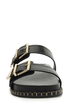 Gleaming buckles and a stitched welt add shine and texture to a weekend-ready slide sandal set on a contoured footbed for enhanced comfort. Leather upper/synthetic lining/leather sole Made in Brazil Black Slide Sandals With Buckle Closure, Black Slide Mules With Buckle Closure, Leather Slip-on Slides With Buckle Closure, Leather Double Strap Slides With Buckle Closure, Modern Leather Slides With Buckle Closure, Modern Black Slides With Buckle Closure, Black Open Toe Slides With Buckle Closure, Modern Slide Mules With Buckle Closure, Black Sandals With Rectangular Buckle Closure