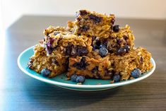 blueberries and oatmeal bars stacked on top of each other in a plate