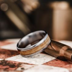 two wedding rings sitting on top of a checkered table