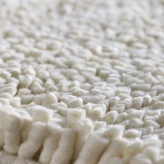 a close up view of a white rug