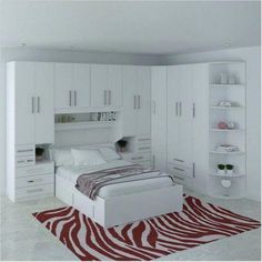 a bedroom with white cabinets and a zebra rug