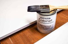 a paint can with a brush on top of it