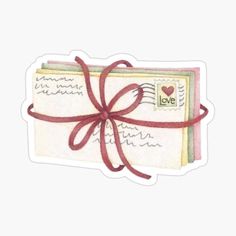 an envelope with a red ribbon tied around it and the word love written on it