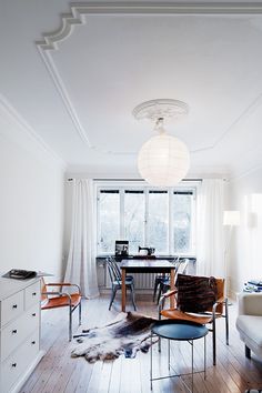 a living room filled with furniture and a large window