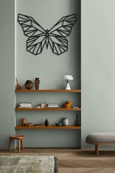 a living room with shelves and a butterfly sculpture on the wall above it, along with a bench