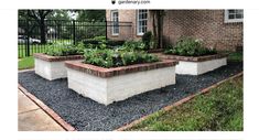 an image of a garden in the middle of a yard with plants growing out of it