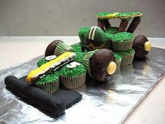 a cake made to look like a race car with cupcakes in the shape of cars