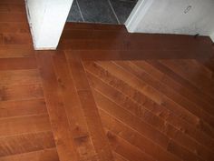 a wooden floor with white walls and wood floors