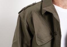 "You are viewing a vintage 80s military parka coat / long jacket in green. Made of thick cotton canvas fabric. Four front pockets. Great classic fit with very masculine vibe. Practical and good looking coat with a button and zip up fastening. Condition: very good vintage. Model measurements: 6 ft (180 cm), he wears size available SIZE Suggested size: M. To be sure it would fit please follow measurements bellow. FLAT Measurements: Length from shoulders: 29\" / 73.5 m Armpit to armpit: 21\" / 53.5 Vintage Green Parka For Outdoor, Oversized Military Cotton Utility Jacket, Vintage Parka With Flap Pockets For Outdoor, Vintage Outdoor Parka With Flap Pockets, Vintage Khaki Parka For Outdoor, Vintage Green Parka For Streetwear, Vintage Streetwear Parka With Pockets, Retro Khaki Utility Jacket With Pockets, Vintage Outerwear With Cargo Pockets For Outdoor