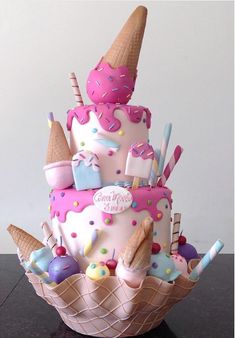 a cake with ice cream cones, candy and candies on it's top