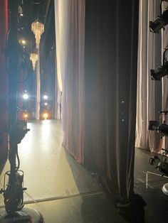 an empty stage with lights and curtains