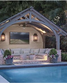 an outdoor living area next to a swimming pool