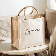 a bag with the word grace on it sitting on a table next to a chair