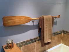 a bath room with a wooden paddle on the wall