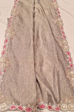 Beautiful handcrafted border on Tissue fabric with hand embroidery. Unstitched Dupatta With Embroidered Border For Reception, Eid Reception Dupatta With Embroidered Border, Beige Chanderi Dupatta For Reception, Festive Embroidered Border Dupatta For Reception, Embroidered Raw Silk Traditional Wear For Reception, Raw Silk Traditional Wear With Embroidered Border For Reception, Silk Dupatta With Embroidered Border For Reception, Festive Beige Saree With Intricate Embroidery, Bohemian Embroidered Fabric With Zari Work For Celebrations