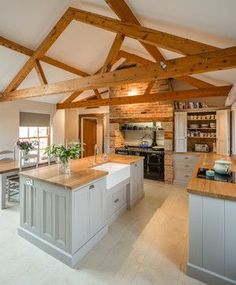 a kitchen with an island and wooden beams