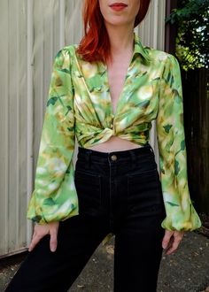 A lil '90s meets '70s going on with this baby! Collared crop length blouse featuring a v-neckline, 2-button front, and adjustable tie closure at front. Long voluminous sleeves with an elasticated cuffs. Relaxed fit. Satin fabrication in a lemon lime blue pattern. Love this baby paired with some high rise denim! Tie can be worn tied at front or back. Features: Crop length blouse Blousy, relaxed fit Collared v-neckline 2-Button front Tie closure at hem Long voluminous sleeves with elasticated cuff Denim Tie, Voluminous Sleeves, Skirt Jumpsuit, All Black Everything, High Rise Denim, Lemon Lime, Girl Bands, Crop Blouse, Blue Pattern