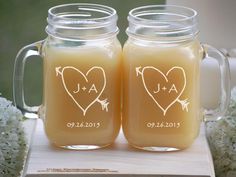 two mason jars filled with liquid sitting on top of a table