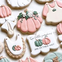 some decorated cookies are laying out on a white tablecloth with words and pumpkins