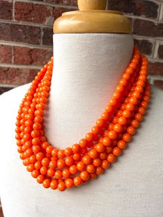 A lightweight beaded multi strand statement necklace made with bright orange swirl acrylic beads. The necklace is made with 6 strands but more options are listed. - 6 strands (more strands are listed) - Shortest strand measures approximately 18.5-20.5" long (length will vary depending on the clasp chosen) - Clasp is stainless steel (gold filled, sterling silver, and gold stainless steel are also available) - Connector is lead free pewter- 2" stainless steel extender chain- Beads measure 10mmA ch Orange Statement Necklace, Silver Jewelry Box, Chunky Statement Necklace, Celestial Necklace, Necklace Chunky, Bird Necklace, Station Necklace, Silver Moon, Moon Charm