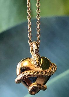 The Wise Heart Charm Necklace in Gold is a Symbol of Wisdom Anchored in Love This stunning charm necklace was design to remind you, "Knowledge becomes wisdom when it's applied with love." The fully three dimensional design features a beautiful snake wrapping and twisting around a full heart. This unique charm design is hung on the chain by a loop of the snake's body instead of a basic jump ring. Let this ancient symbol of wisdom mark the lessons you have learned deep in your heart. It's the perf Symbolic Snake Shaped Necklace For Gift, Symbolic Snake-shaped Necklace For Gift, Symbolic Snake Necklace As A Gift, Snake-shaped Engraved Jewelry Gift, Engraved Snake-shaped Jewelry Gift, Unique Snake Shape Necklace For Gift, Spiritual Snake-shaped Necklace For Gifts, Luxury Snake-shaped Jewelry For Gifts, Luxury Snake-shaped Jewelry Gift