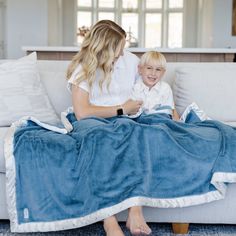 Mom and son hanging out at home spending time snuggled under a cozy blue and white satin back toddler blanket. Saranoni Blankets, Luxury Blankets, Ivory Throw Blanket, Blanket Forts, Toddler Blankets, Sakura Bloom, Blanket Fort, Toddler Blanket, Lap Blanket