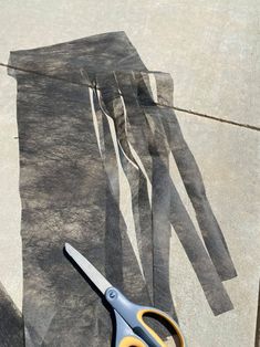 a pair of scissors sitting on top of a piece of paper