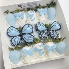 some blue butterflies and strawberries in a box