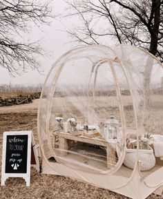 a tent set up in the middle of a field