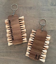 two wooden keychains that have toothpicks in the shape of numbers on them