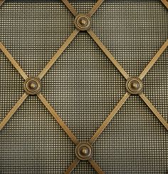 an up close view of the metal and wood frame on a wall with grids