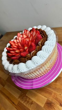 there is a large cake with strawberries on top