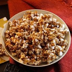 a bowl filled with popcorn next to a keyboard