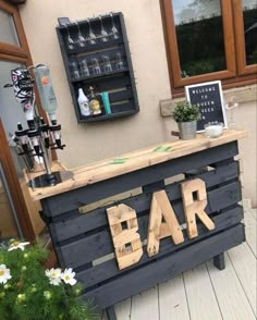 a bar made out of wooden pallets with the word bar written on it's side