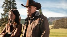 an older man and young woman wearing cowboy hats