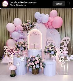 there are balloons and decorations on the stage for an event in pink, white and blue