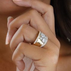 a close up of a woman's hand with a ring on her left finger