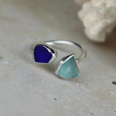 This ring is entirely handcrafted by me in my home studio in Wales The sea glass was hand picked by myself on my local beach, St Mary's Well Bay, Penarth. The sea glass has been set in sterling silver bezels. The ring is UK size K One ring included in price. ------Instructions------ For a longer and better quality life for your handmade silver item, please avoid contact with chemicals similar to perfume, detergents and soaps.  ------Postage------ Each item of jewellery is delivered in a customised Searosejewellery jewellery box. If you order one item, it will be delivered in a sturdy envelope. If you order two or more, your items will be delivered in a sturdy customised cardboard box. All packaging is eco friendly and recyclable.  ------International shipping------ I ship all items as stan Handmade Sea Glass Ring Jewelry, Sea Glass Silver Ring, Handmade Adjustable Sea Glass Rings, Handmade Blue Sea Glass Jewelry, Sea Glass Rings, Sea Glass Ring, Nickel-free Blue Sea Glass Jewelry, Ring Wire, Bold Rings