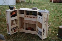 an outdoor kitchen made out of pallets is shown in the middle of a field